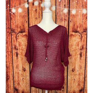 Lightweight short sleeve top with interesting details. Fits large w/ snug waist.